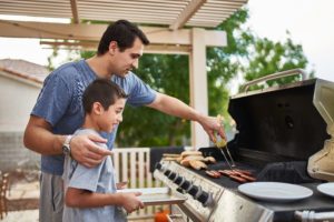 Father and son grilling barbeque